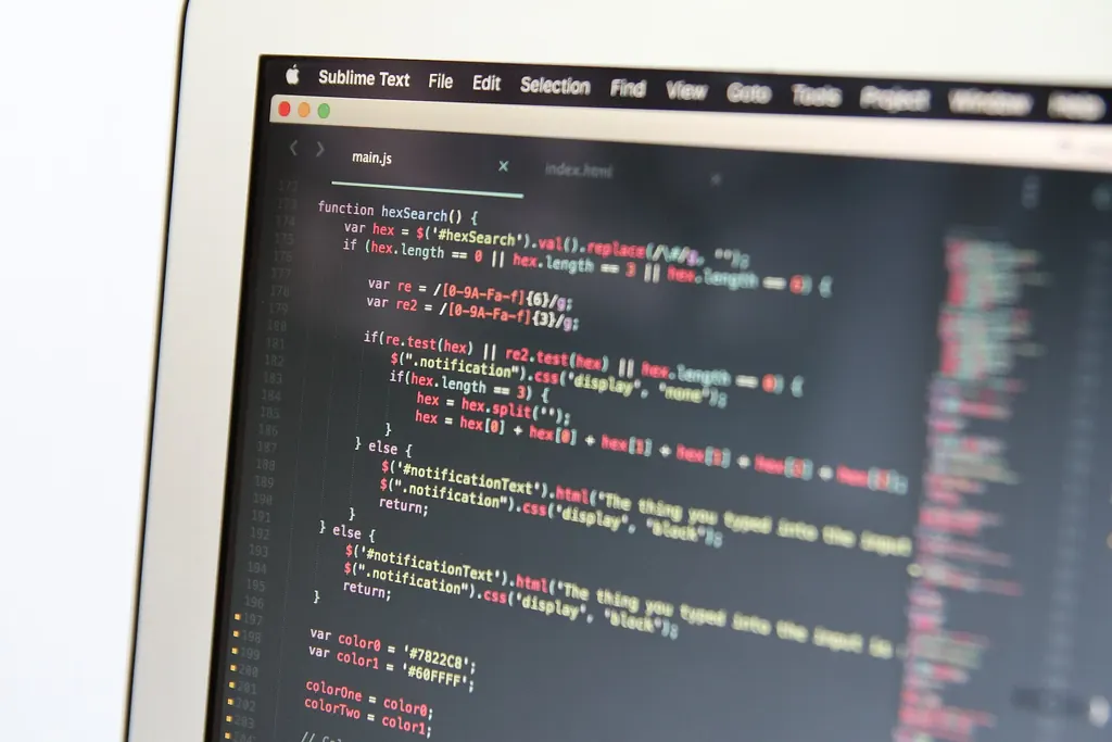 Close-up of a laptop screen showing lines of source code in a dark code editor