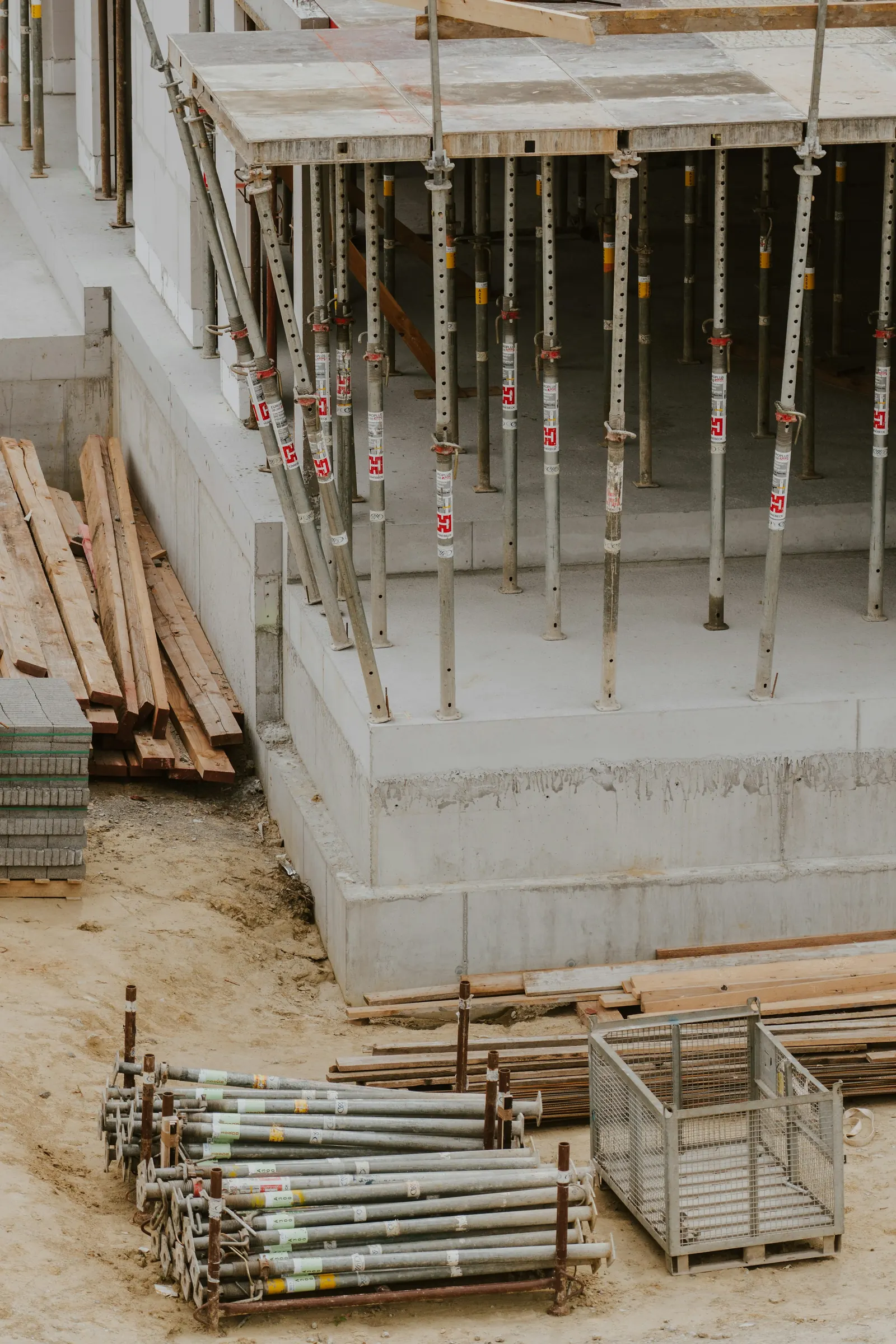 A concrete foundation with formwork props on a building site